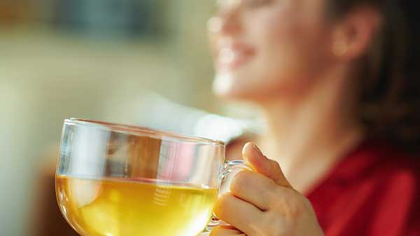 woman drinking ginger tea for gut health