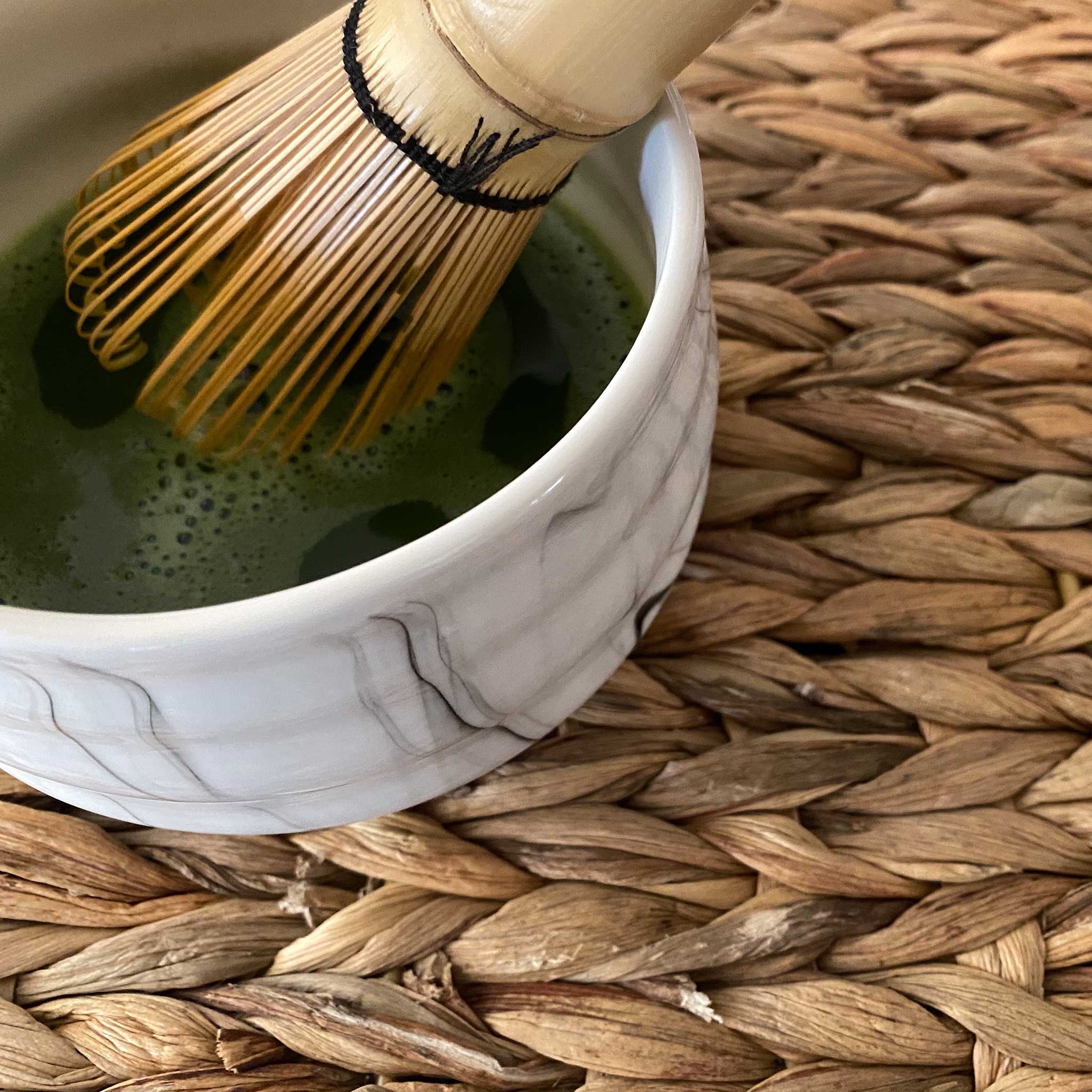 whisking matcha in ceramic matcha bowl