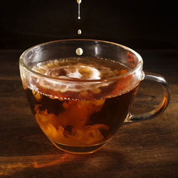 adding a drop of milk to english breakfast tea