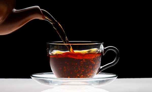 what makes black tea black? pouring black tea into cup