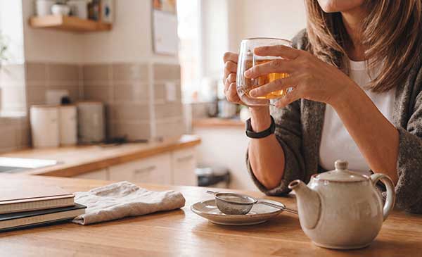 woman drinking cup of loose leaf tea for a weight-conscious routine