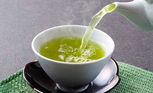 steaming cup of green tea for health