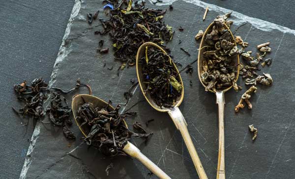 three spoonfuls of different types of black tea