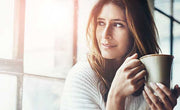 woman drinking cup of caffeinated black tea in the morning