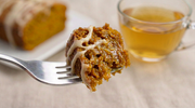 a bite of pumpkin chai tea loaf on a fork with cream cheese drizzle