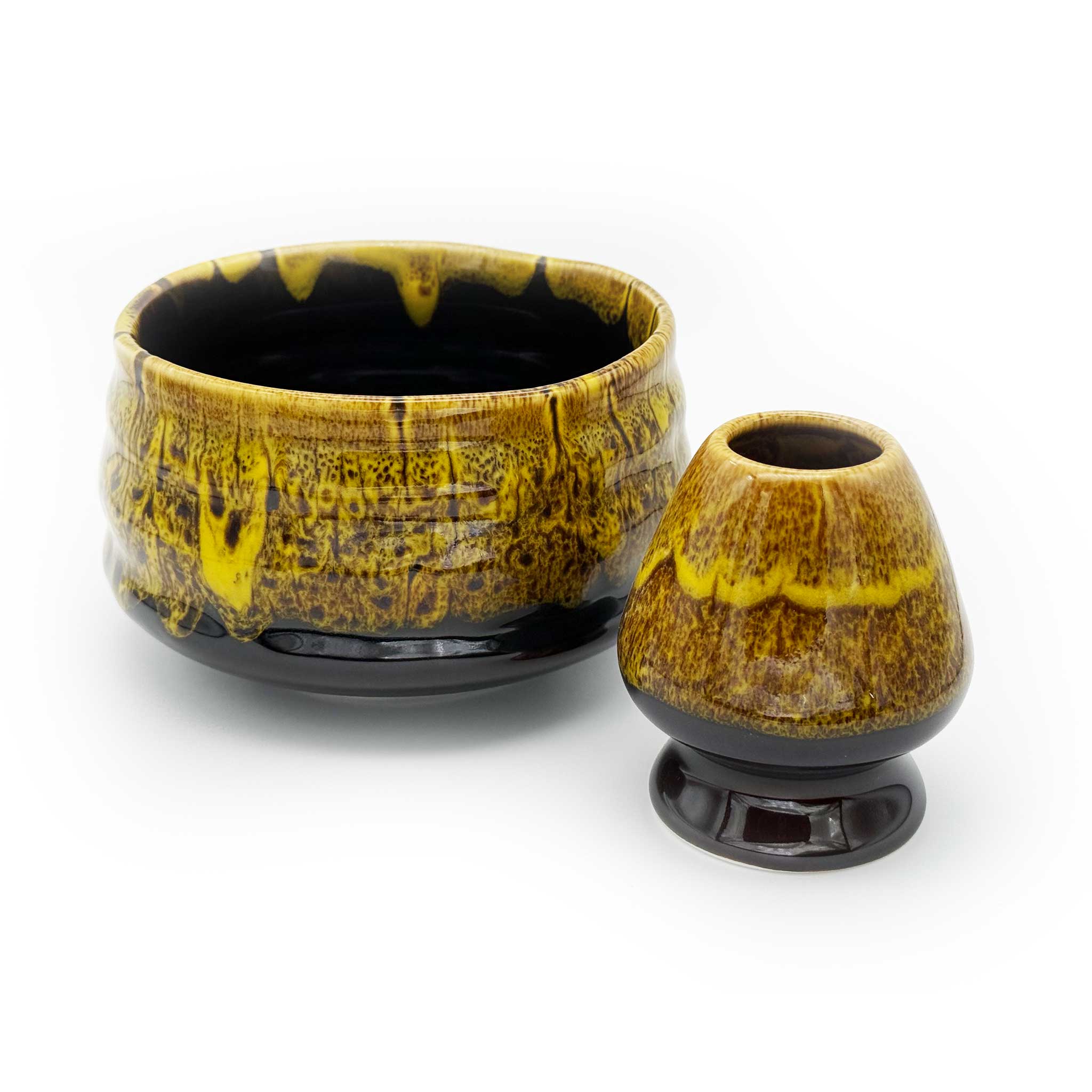 Two ceramic bowls with a yellow and black glaze on a white background