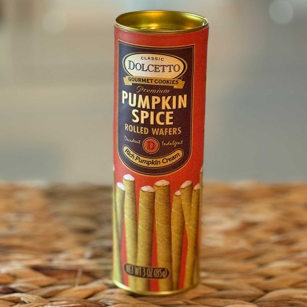 Canister of Dolcetto Pumpkin Spice Rolled Wafers on a woven surface