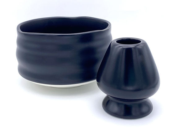 A set of black ceramic matcha bowl and whisk holder.