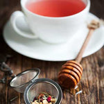 Dragon Fruit Tea in cup with loose tea and honey