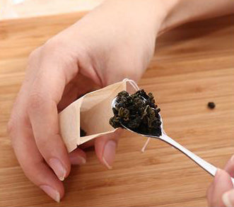 filling a compostable tea bag with tea drawstring wood fiber biodegradable