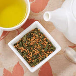 genmaicha green tea in dish with teapot and cup of brewed genmaicha tea